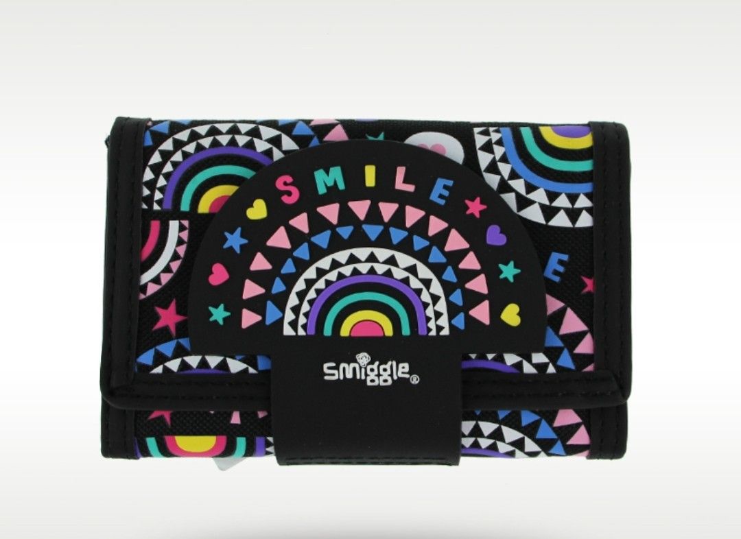 Smiggle Wallet Rainbow (Category: Wallets & Card holders) located in Paranaque City. Submitted by ipuno_ (Listing ID 1454549614, Image 1). Description: - Adorable Smiggle wallet with a vibrant rainbow and smile design. - Classic black base with colorful accents. - Secure and easy velcro closure. - Interior features multiple card slots. - Includes a clear ID window for easy identification. - Convenient zippered pocket for coins. - Ideal for childr
