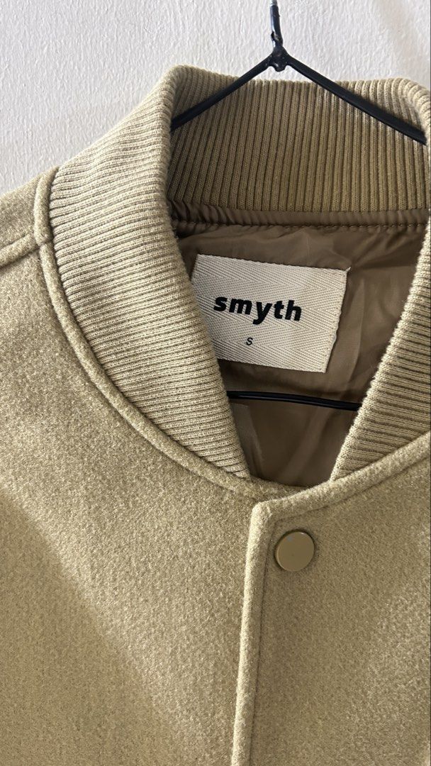 Smyth Varsity Jacket - Beige with S Logo and Patches (Category: Coats, Jackets and Outerwear) located in Manila. Submitted by pvcanlapan (Listing ID 1454526864, Image 2). Description: - Cool Smyth varsity jacket - Beige body with white sleeves - Features a large 'S' logo on the chest - NASA and other patches on the left sleeve - Ribbed collar, cuffs, and hem - Button-up front - Ideal for casual wear.