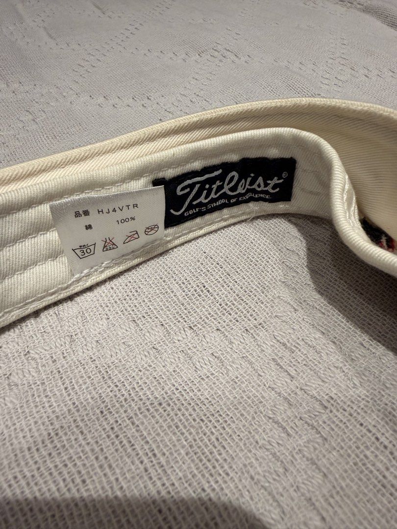Titleist Pro V1 Golf Visor / Sun Visor (White/Red) (Category: Caps & Hats) located in San Juan City. Submitted by miyukabinet (Listing ID 1454517367, Image 2). Description: Authentic Titleist Golf Visor * Model Code: HJ4VTR * Material: 100% Cotton * Features: Embroidered Titleist logo on front, Pro V1 text on the side, and FootJoy (FJ) logo on the side. Adjustable velcro strap at the back for a custom fit. * Inclusions: Visor only Perfect for gol