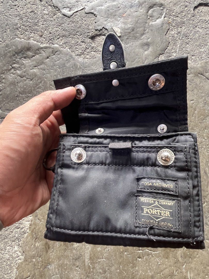 Toga x Porter (Category: Luxury Bags & Wallets) located in Manila. Submitted by thevintage90_sretro. (Listing ID 1454473208, Image 2). Description: Toga x Porter black nylon wallet features distinctive silver-tone metal concho hardware on the front closure strap and the classic Yoshida & Co. Porter label. Made in Japan Excellent condition Missing sling Legit DM.