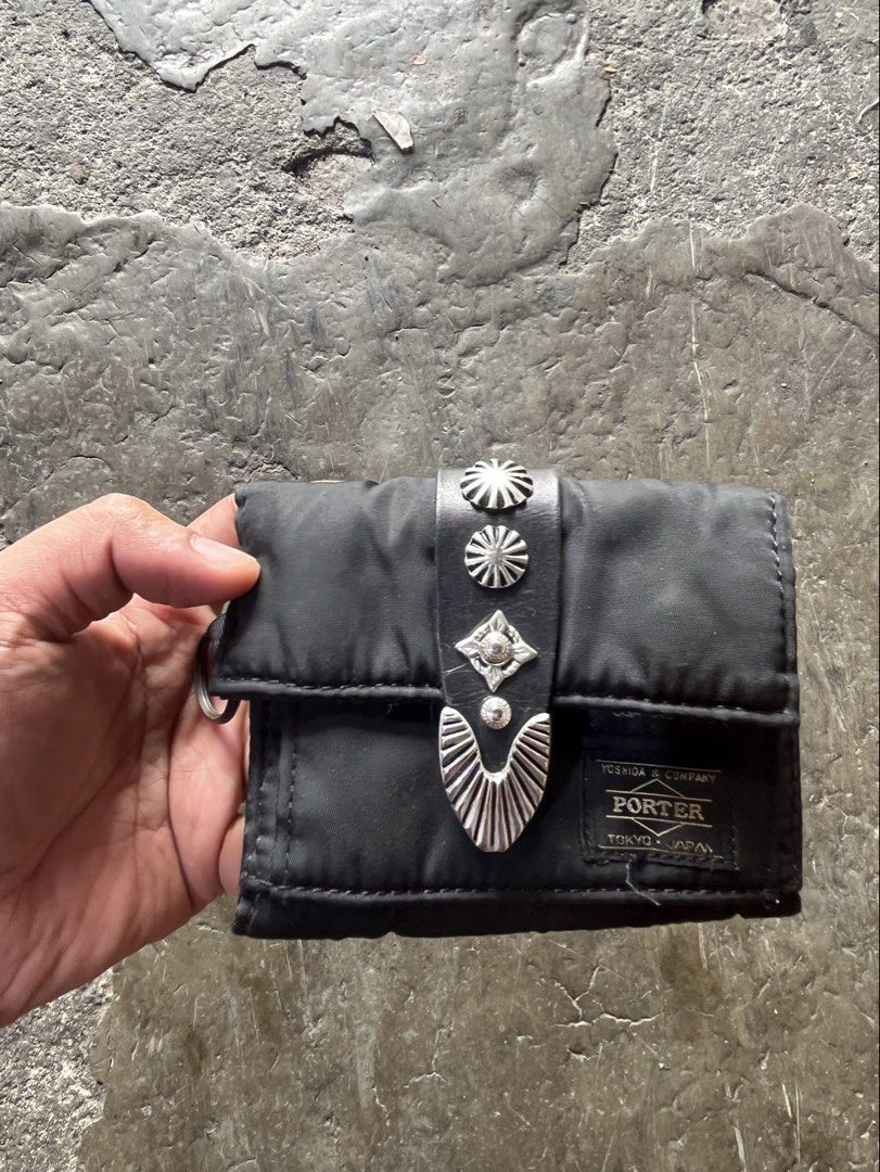 Toga x Porter (Category: Luxury Bags & Wallets) located in Manila. Submitted by thevintage90_sretro. (Listing ID 1454473208, Image 1). Description: Toga x Porter black nylon wallet features distinctive silver-tone metal concho hardware on the front closure strap and the classic Yoshida & Co. Porter label. Made in Japan Excellent condition Missing sling Legit DM.