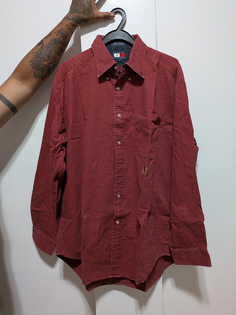 Tommy Hilfiger Burgundy Button Down Shirt M (Category: Tshirts & Polo Shirts ) located in Tubod. Submitted by the_prime1998 (Listing ID 1454505690, Image 3). Description: - Classic Tommy Hilfiger button-down shirt - Color: Burgundy - Features embroidered crest logo on chest pocket - Material: 100% Cotton - Made in Thailand - Size: Medium (M) - Ideal for casual and smart-casual occasions.