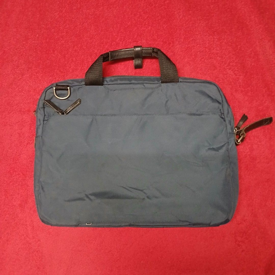 Tumi Navy Blue Ballistic Nylon Briefcase / Laptop Bag (Category: Briefcases) located in Cagayan de Oro. Submitted by susanthrifts (Listing ID 1454506263, Image 2). Description: ​Brand: Tumi ​Model / Style Ref: 61011INDOP ​Type: Briefcase / Laptop Attache / Work Bag ​Color: Navy Blue with Black Leather Trim & Dark Grey Interior ​Material: Ballistic Nylon Exterior, Nylon Lining, Genuine Leather Accents ​Features: ​Multi-compartment main interior wi