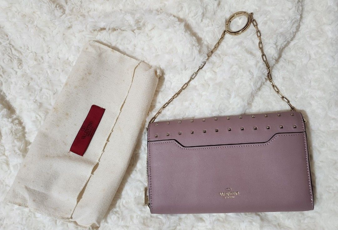 Valentino Garavani Studded-texture leather wallet (Category: Luxury Bags & Wallets) located in Taytay. Submitted by luxebagcray (Listing ID 1454487782, Image 2). Description: - Authentic Valentino Garavani Rockstud wallet - Chic dusty rose pink leather - Signature gold pyramid studs - Secure zip-around closure - Spacious interior with multiple card slots and compartments - Perfect for organizing your essentials - Comes with original dust bag.