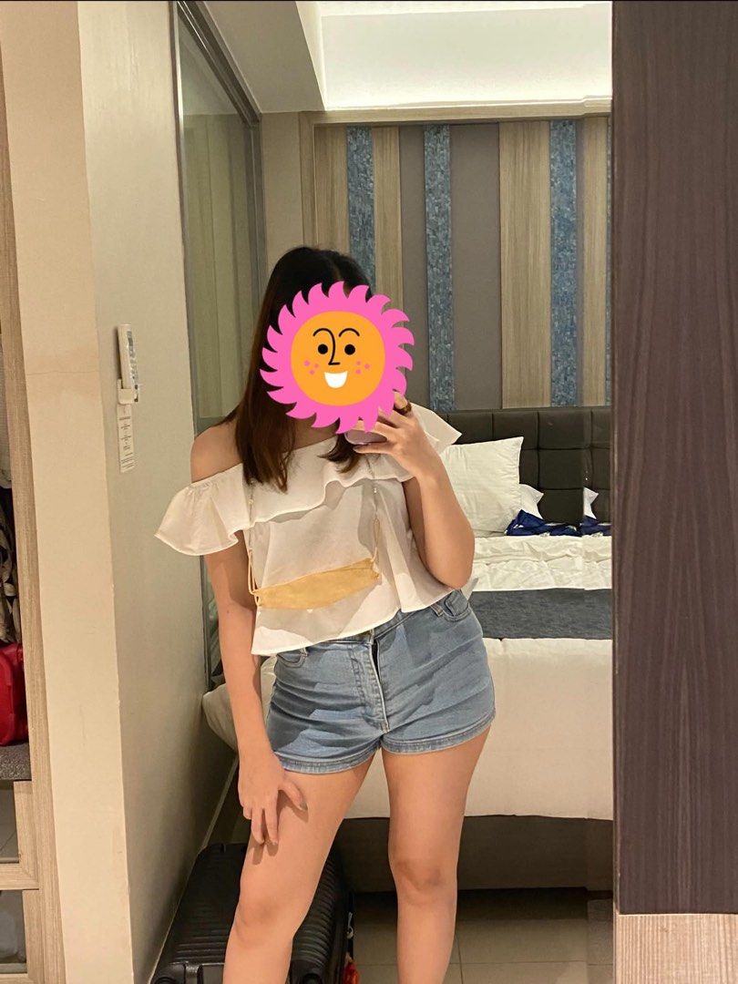 White off-shoulder ruffled top with adjustable straps (Category: Blouses) located in Antipolo. Submitted by errrilemon (Listing ID 1454512627, Image 2). Description: - Cute white off-shoulder top with strap - Ruffled detail across the chest - Flutter sleeves - Adjustable straps for a perfect fit - Layered design at the bottom - Versatile: pairs well with jeans or shorts - Ideal for casual outings.