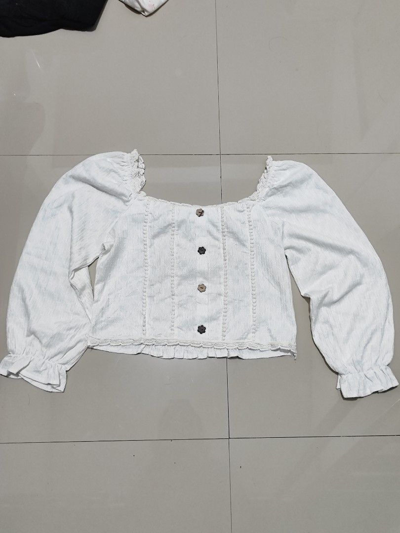 White Square Neck Puff Sleeve Blouse with Button Detail (Category: Blouses) located in Dasmarinas. Submitted by cronaur (Listing ID 1454521473, Image 1). Description: - Fits M/L - Never worn it (Too big for me TvT) - check slides for flaw/s - color may vary due to lighting.