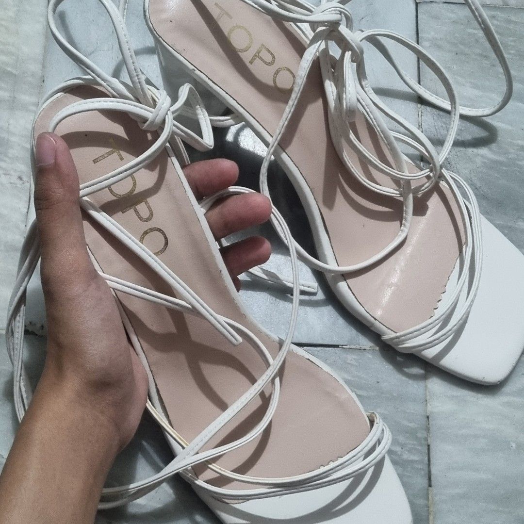 White Strappy Lace-Up Block Heels (Category: Sandals) located in Las Pinas. Submitted by cozychic19 (Listing ID 1454445340, Image 2). Description: Featuring an open square toe and delicate wrap-around ankle ties RFS: Wrong Size With box Minor scuffing, peeling, marks on the heel edge.