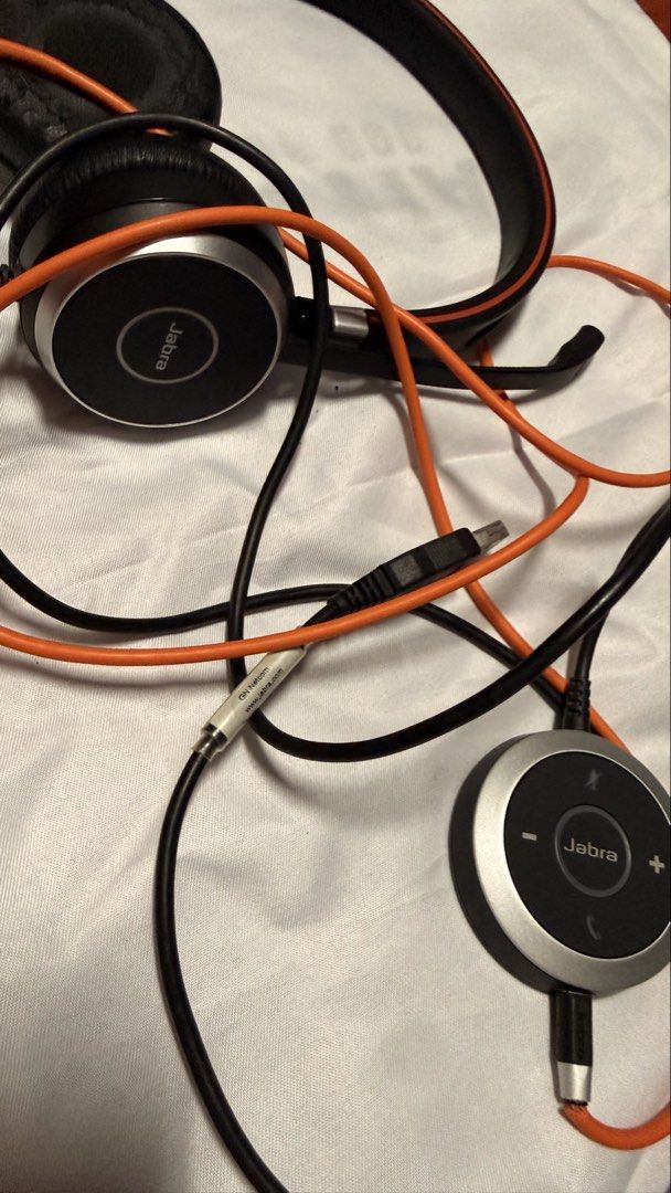 Working but defective Jabra Evolve 40 Stereo Headset with Mic (Category: Headphones & Headsets) located in Makati City. Submitted by Everythingnice2022 (Listing ID 1454521973, Image 2). Description: - Jabra Evolve 40 Stereo Headset - Color: Orange and Black - Includes microphone boom - Features inline control unit - Cable is intact - Earcups show significant wear and tear - Sold as is.