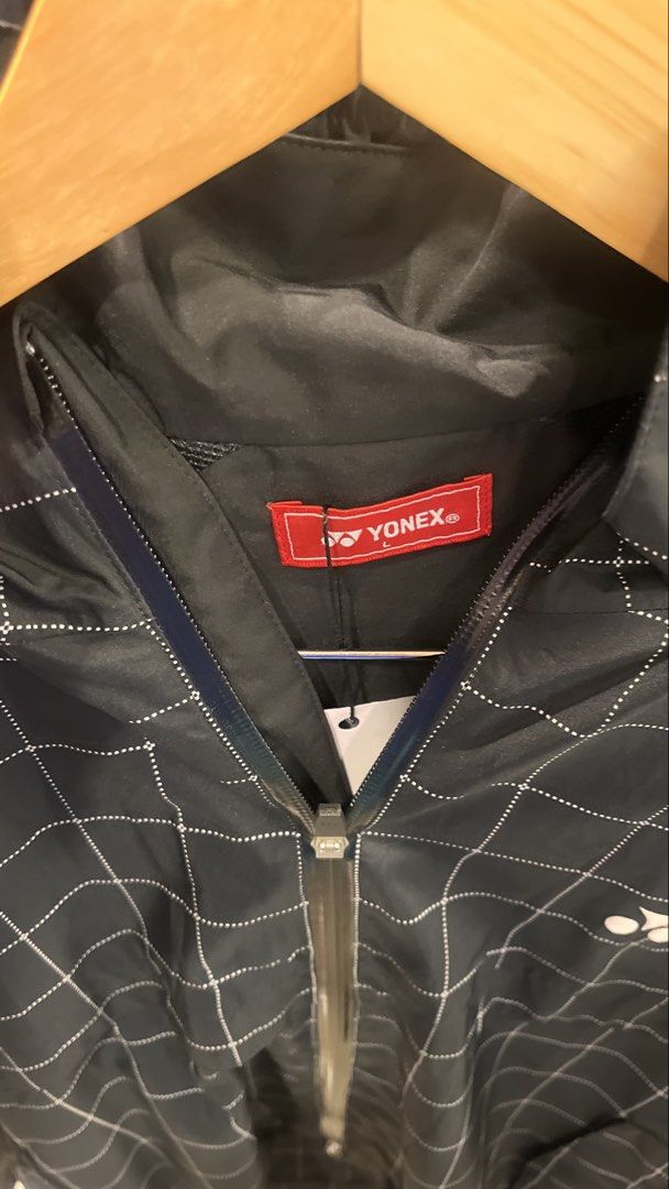 Yonex Technical Athletic Badminton Jacket (Autumn Rain Full-Zip) (Category: Coats, Jackets and Outerwear) located in Dinalupihan. Submitted by banditvaultco (Listing ID 1454496809, Image 2). Description: Authentic - Pattern & Color: Features a prominent white grid (windowpane) pattern over a solid matte black base. Yonex double twist logo - Lightweight, windproof synthetic performance fabric - Size Large - Excellent as new condition.