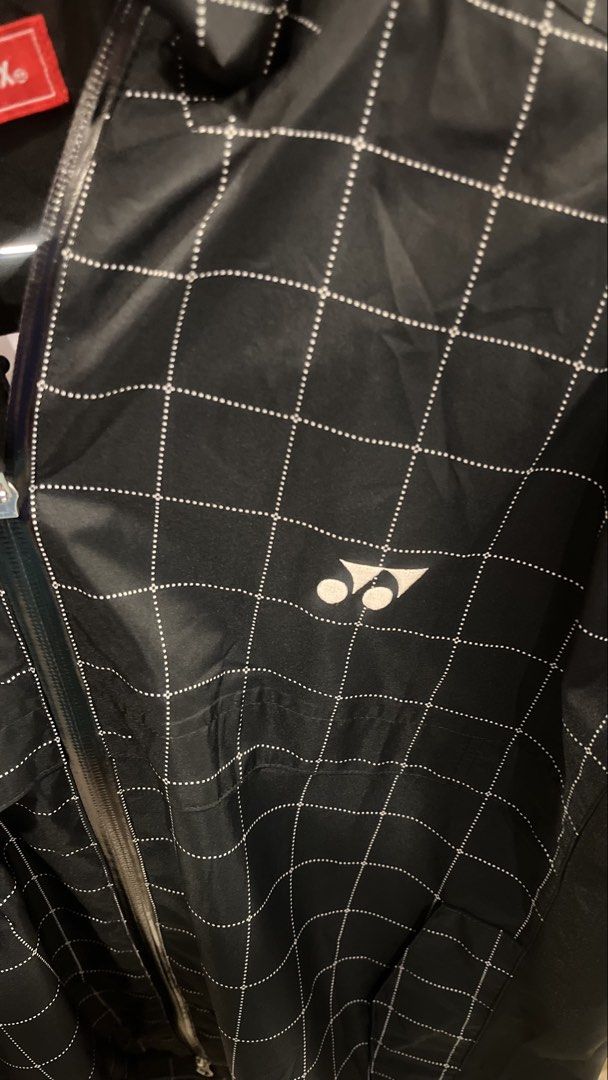 Yonex Technical Athletic Badminton Jacket (Autumn Rain Full-Zip) (Category: Coats, Jackets and Outerwear) located in Dinalupihan. Submitted by banditvaultco (Listing ID 1454496809, Image 3). Description: Authentic - Pattern & Color: Features a prominent white grid (windowpane) pattern over a solid matte black base. Yonex double twist logo - Lightweight, windproof synthetic performance fabric - Size Large - Excellent as new condition.