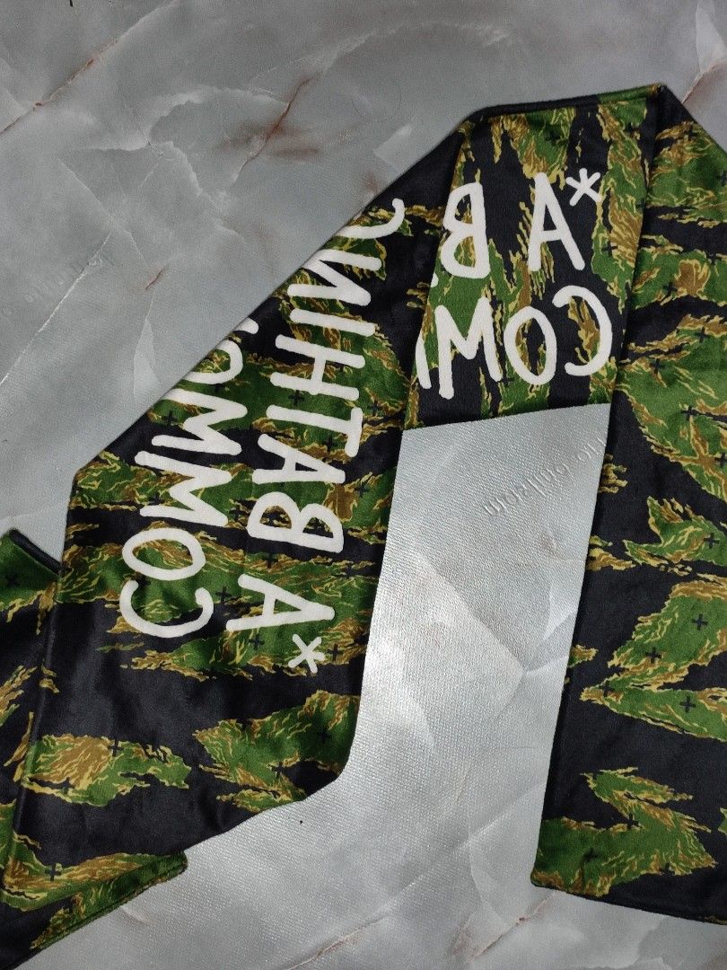 A BATHING APE x COMMON SENSE Tiger Camo Scarf (Category: Luxury Accessories) located in Taguig. Submitted by inzanne.vesture (Listing ID 1454722459, Image 3). Description: - Authentic A BATHING APE® x COMMON SENSE collaboration scarf. - Features iconic tiger camouflage print. - Bold white text branding across the center. - Perfect accessory to elevate your style. - Approximate length: 140cm..