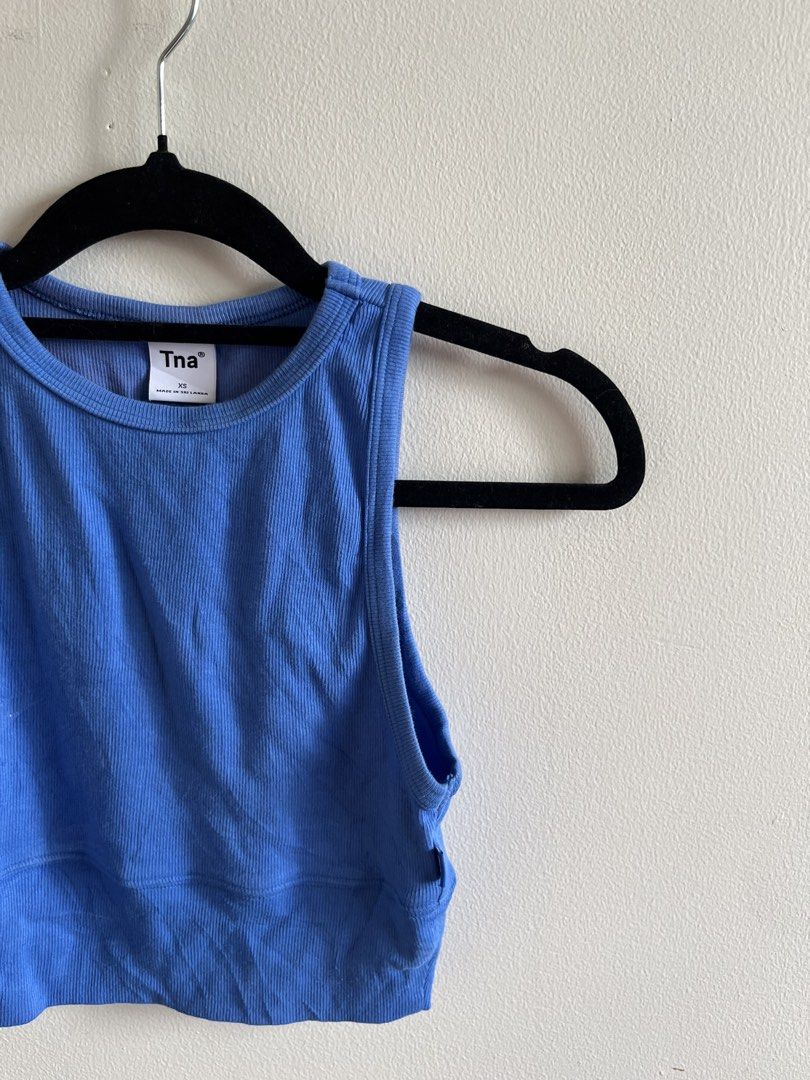 Aritzia Tna Blue Ribbed Cropped Tank Top (Category: Activewear) located in Muntinlupa City. Submitted by lovedbysabel (Listing ID 1451443546, Image 1). Description: Blue Tna Tank Top Soft ribbed fabric with a flattering cropped fit. Great for layering or wearing on its own. I only wore this once for a Pilates class. Since it fits me perfectly, I didn't need to wear a bra underneath. The fit is supportive enough to wear on its own, making it extra