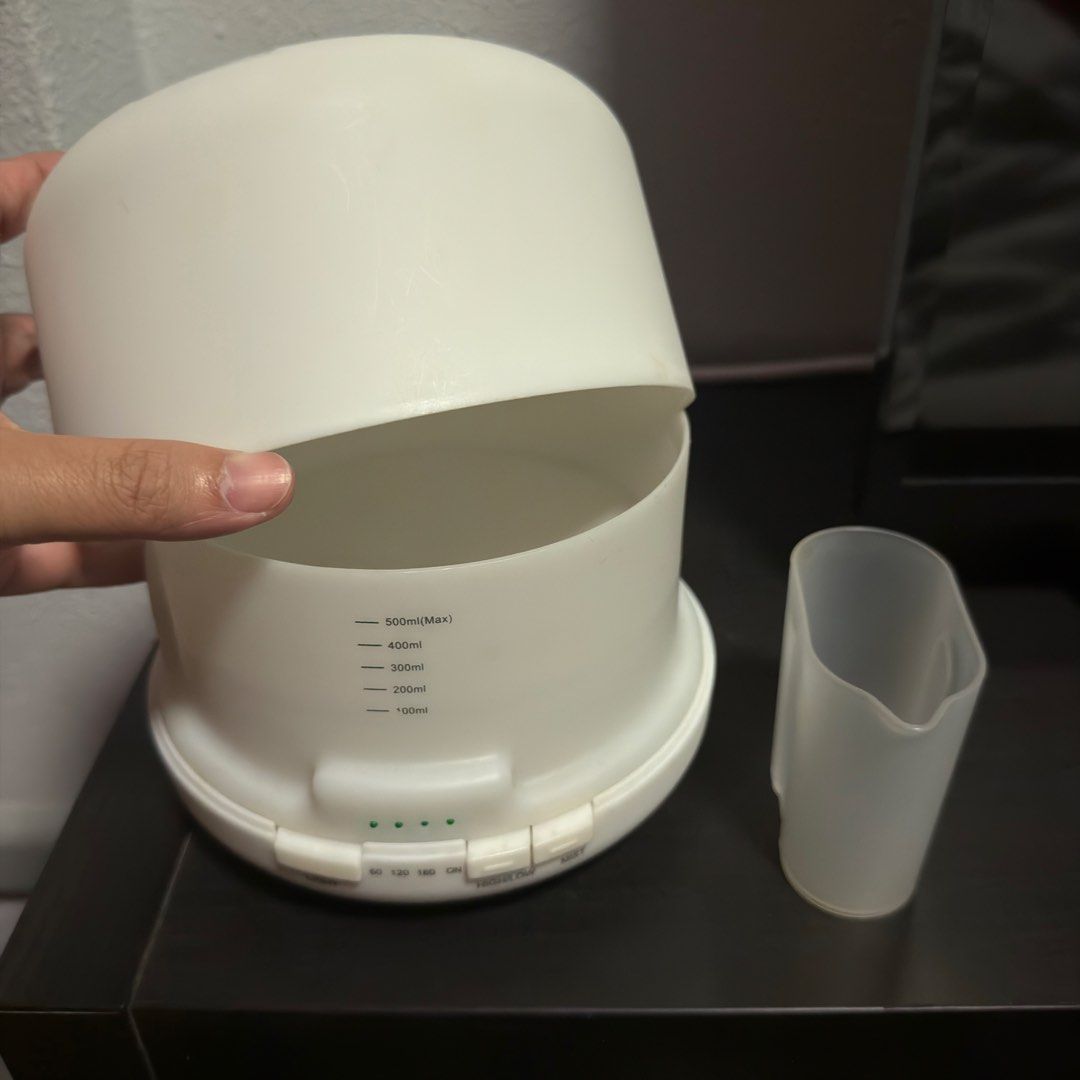 Aroma Diffuser (without power plug) (Category: Home Fragrance) located in Singapore. Submitted by valensia_s (Listing ID 1454657879, Image 2). Description: - Please note: Does not come with power plug!!! - White aroma diffuser - Compact and modern design - Easy to use with included measuring cup - Suitable for home or office use - Will give a few oil for free.