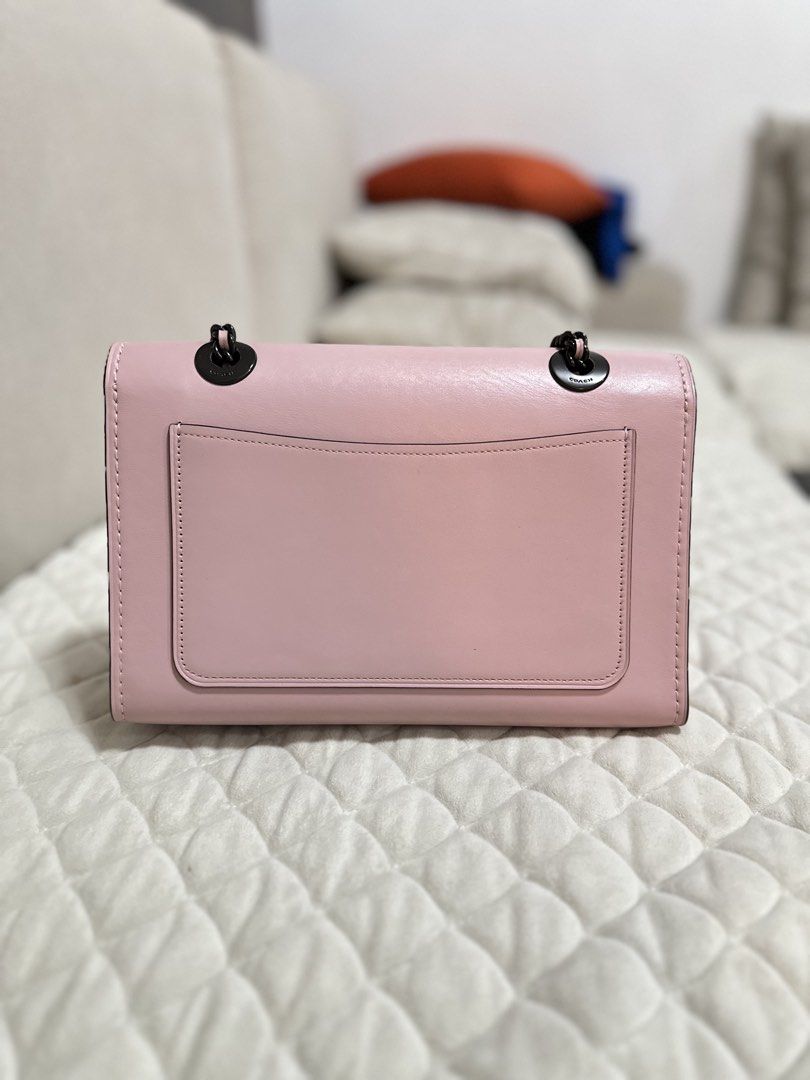 Authentic Coach Aurora Leather Parker Pink Shoulder Bag (Category: Luxury Bags & Wallets) located in Manila. Submitted by luxestuffph (Listing ID 1454693555, Image 3). Description: - Brand: Coach - Color: Pink - Material: Leather - Style: Shoulder Bag - Features: Black chain strap, turn-lock closure, back slip pocket - Condition: Very good except for a small lipstick stain on the side bottom (visible in 4th and fifth photos) -100% authentic.