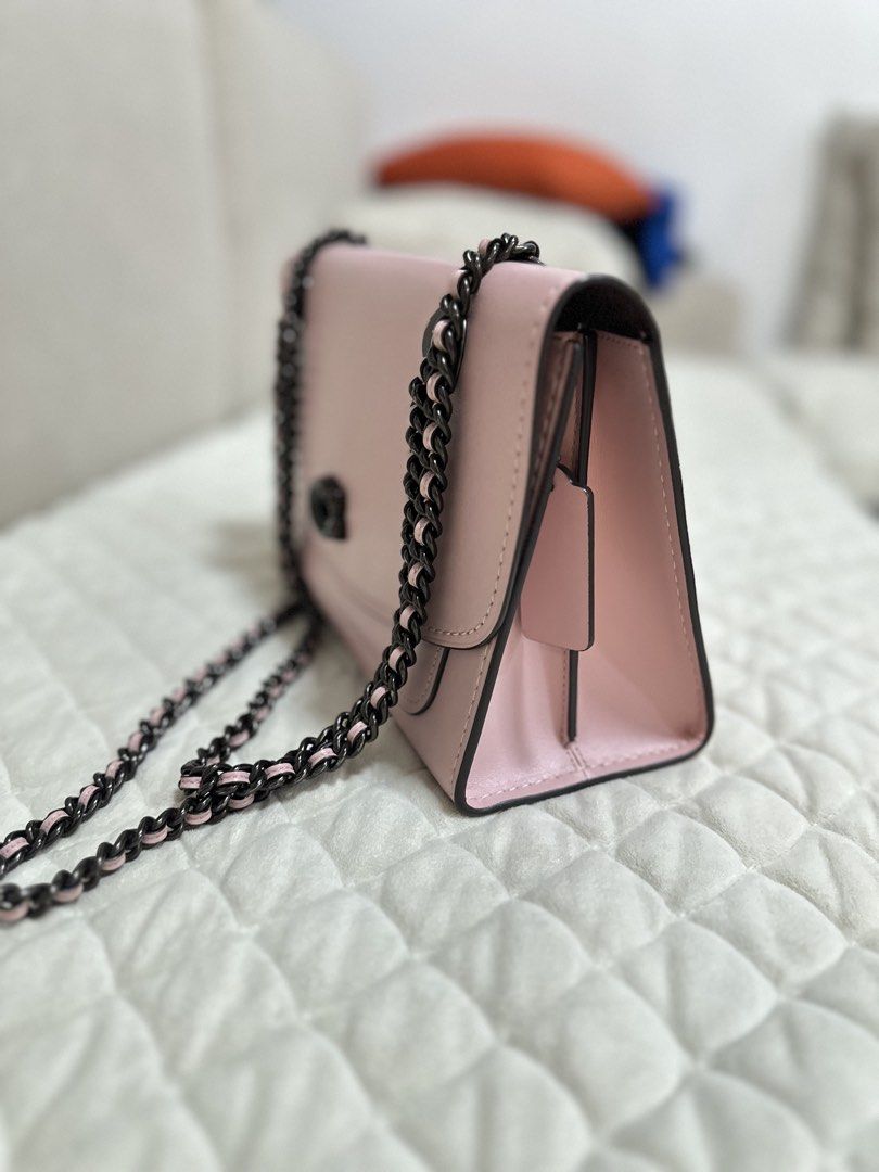 Authentic Coach Aurora Leather Parker Pink Shoulder Bag (Category: Luxury Bags & Wallets) located in Manila. Submitted by luxestuffph (Listing ID 1454693555, Image 2). Description: - Brand: Coach - Color: Pink - Material: Leather - Style: Shoulder Bag - Features: Black chain strap, turn-lock closure, back slip pocket - Condition: Very good except for a small lipstick stain on the side bottom (visible in 4th and fifth photos) -100% authentic.