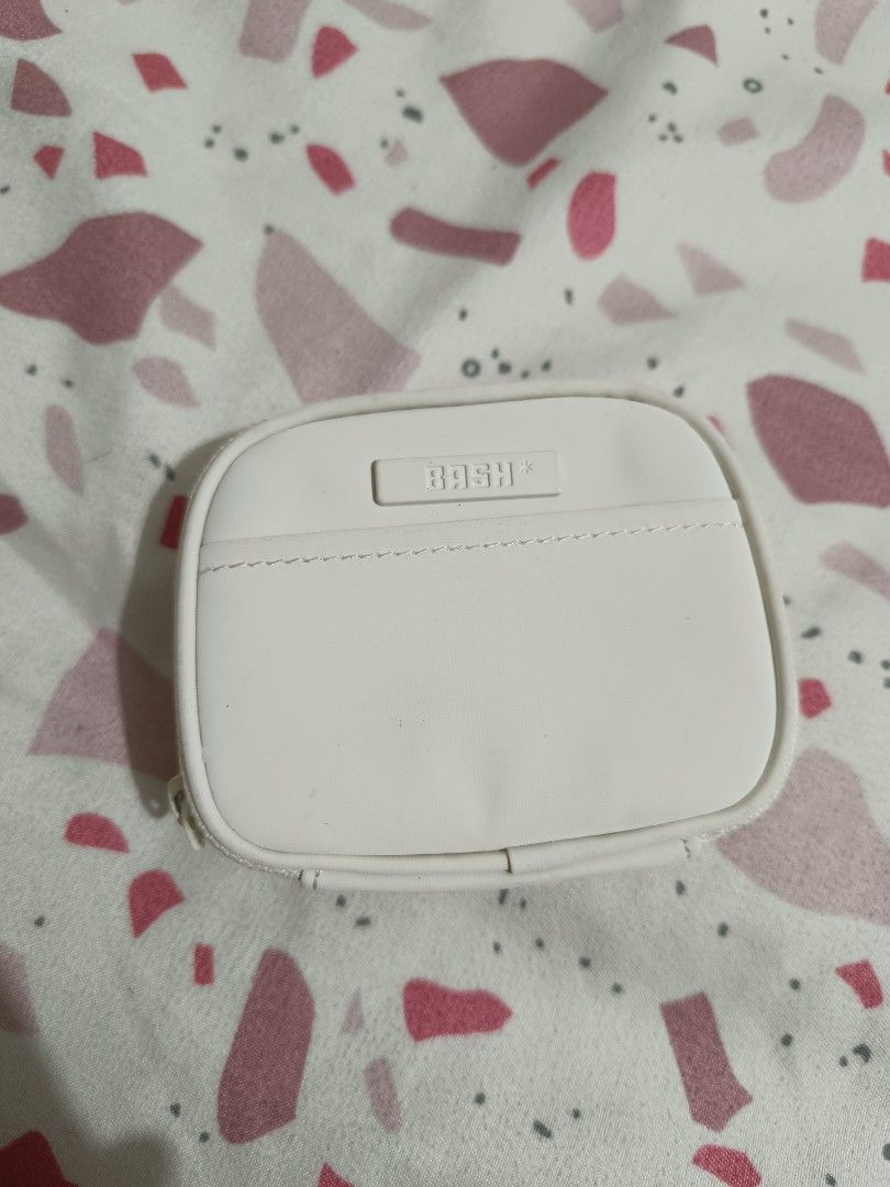 BASH Card Holder (Category: Purses & Pouches) located in Rizal. Submitted by aki12_shop (Listing ID 1454609004, Image 2). Description: - Color: Bone from BASH Manila - Zipper closure for secure storage - Front pocket with stylish stitching detail - Small and compact size, perfect for on-the-go organization - Ideal for keeping small items tidy - still new.