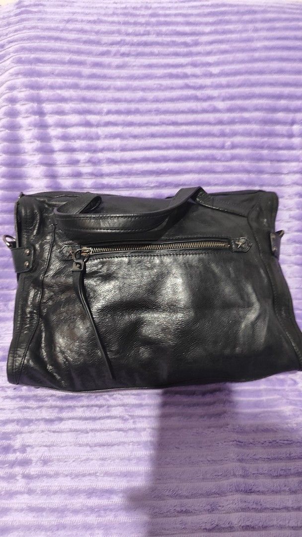 Black Leather Tote Bag with Studs (Category: Tote Bags) located in Manila. Submitted by thecalvinedit (Listing ID 1454746827, Image 3). Description: - Genuine black leather tote bag - Secure zippered main compartment - Convenient exterior zippered pocket - Interior magnetic snap closure pocket - Elegant silver hardware details - Comfortable straps for shoulder or hand carry - Ample space for daily essentials * no sling, but can be replaced..