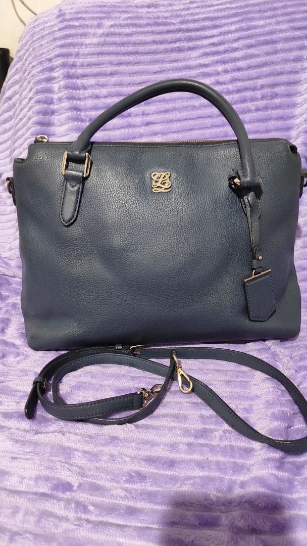 Blue Leather Handbag with Shoulder Strap (Category: Shoulder Bags) located in Manila. Submitted by thecalvinedit (Listing ID 1454748279, Image 1). Description: - Chic blue leather handbag - Features a comfortable top handle - Includes a detachable shoulder strap for versatile wear - Organized interior with multiple compartments - Proudly made in Korea - Please note: Minor wear on handles and corners, as shown in photos..