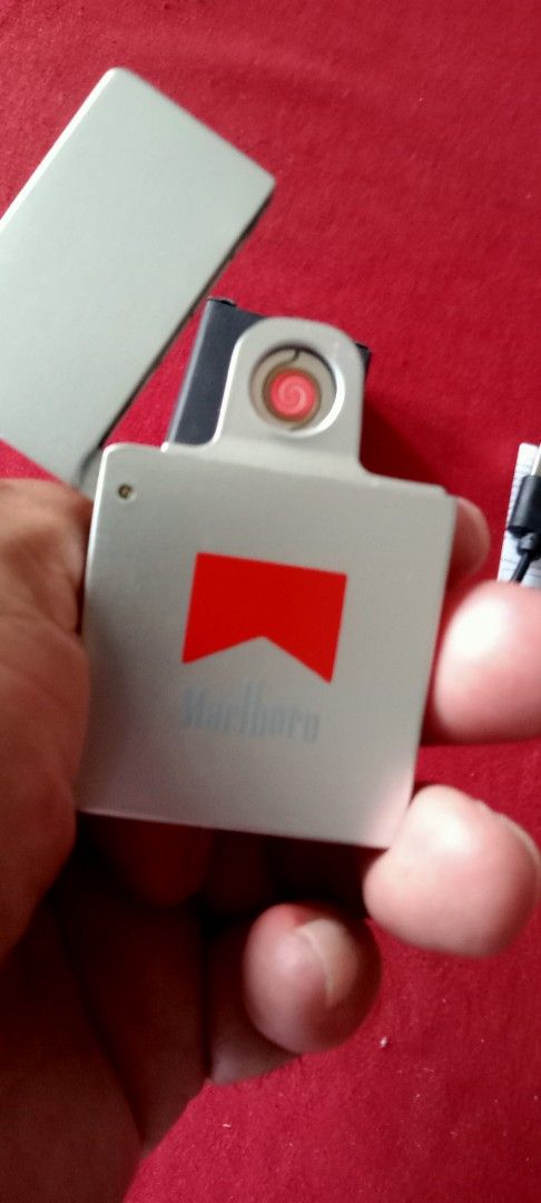Brandnew rechargeable lighter (Category: Craft Supplies & Tools) located in Taytay. Submitted by joselaquino (Listing ID 1454657088, Image 1). Description: Marlboro electric lighter, silver with red logo. USB rechargeable, includes cable. Compact and cool gadget for lighting cigarettes..