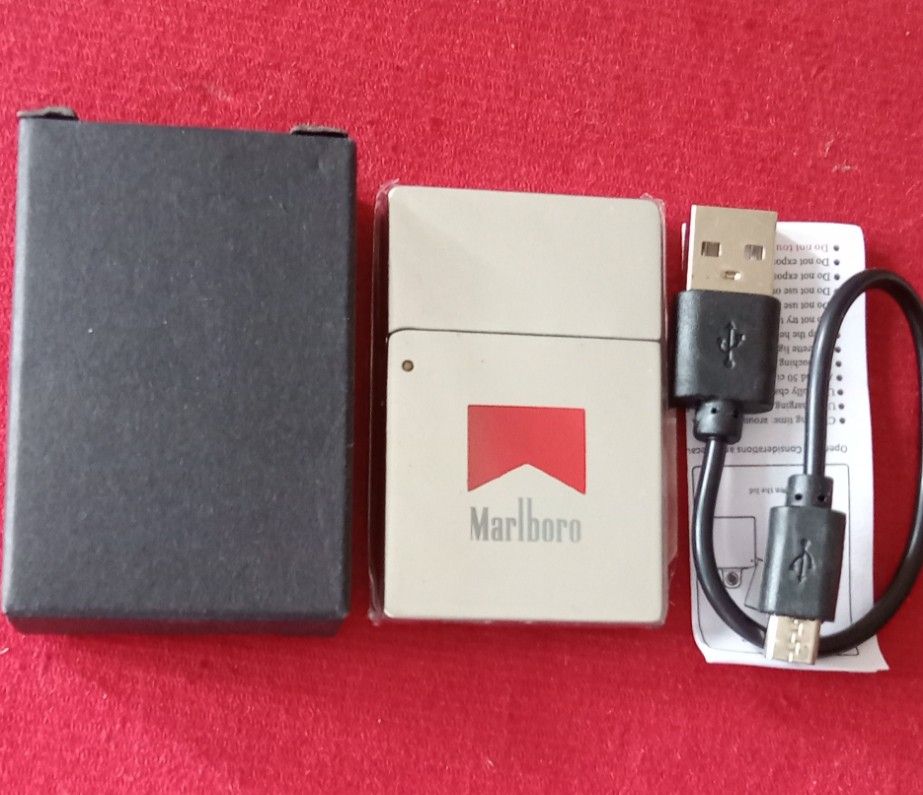 Brandnew rechargeable lighter (Category: Craft Supplies & Tools) located in Taytay. Submitted by joselaquino (Listing ID 1454657088, Image 3). Description: Marlboro electric lighter, silver with red logo. USB rechargeable, includes cable. Compact and cool gadget for lighting cigarettes..
