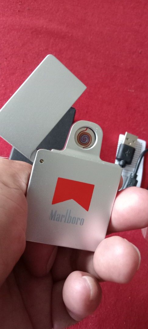 Brandnew rechargeable lighter (Category: Craft Supplies & Tools) located in Taytay. Submitted by joselaquino (Listing ID 1454657088, Image 2). Description: Marlboro electric lighter, silver with red logo. USB rechargeable, includes cable. Compact and cool gadget for lighting cigarettes..