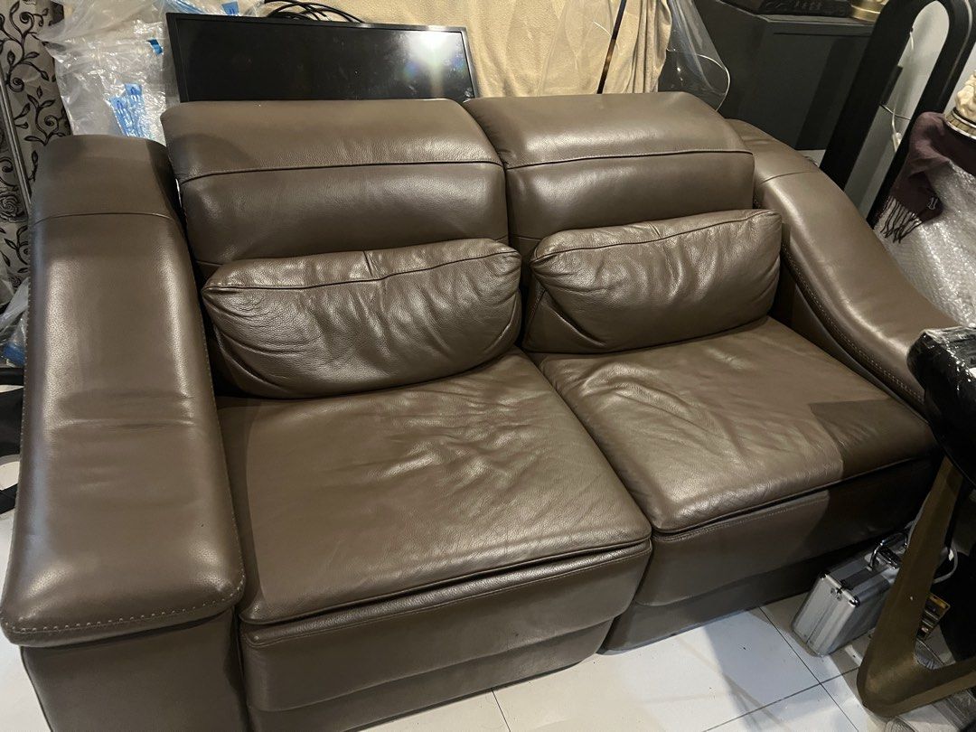 Brown Leather 2-Seater Sofa (Category: Sofas) located in Paranaque City. Submitted by dalumpines80725 (Listing ID 1454630067, Image 1). Description: - Electronic recliner - Comfortable brown leather sofa - Two-seater design - Plush cushions for extra comfort - Soft leather with a nice sheen - Ideal for living rooms or smaller apartments - Solid and durable furniture piece - Ready for its new home.
