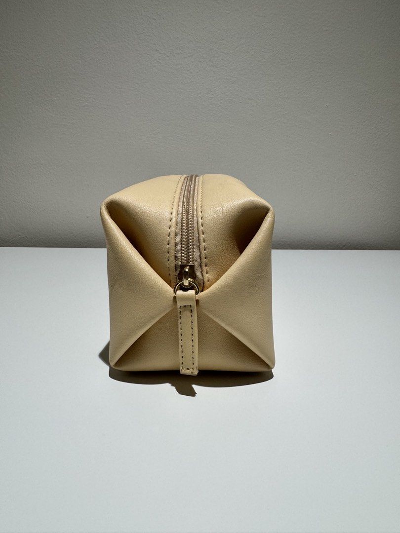 Bvlgari Emirates Exclusive Cosmetic Bag (Category: Luxury Bags & Wallets) located in Quezon City. Submitted by joyeusefille (Listing ID 1454597780, Image 3). Description: - Cream-colored cosmetic bag - Features a small red and gold emblem on the front - Secure zipper closure - Lined with pink fabric inside - Branded with 'Bvlgari Parfums' and 'Emirates' - Ideal for travel or everyday essentials.