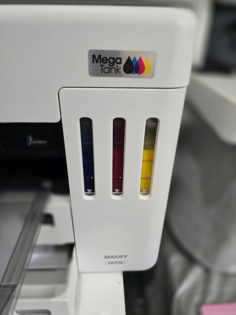 Canon MAXIFY GX7170 Mega Tank Printer (Category: Printers, Scanners & Copiers) located in Paranaque City. Submitted by rekeep (Listing ID 1454715479, Image 2). Description: Reason for Selling: Moving out of PH, Purchased just last March - Canon MAXIFY GX7010 Mega Tank Printer - Features refillable ink tanks - Includes black, cyan, magenta, and yellow ink - Control panel with screen and buttons for scan, copy, and settings - Ideal for home or offi