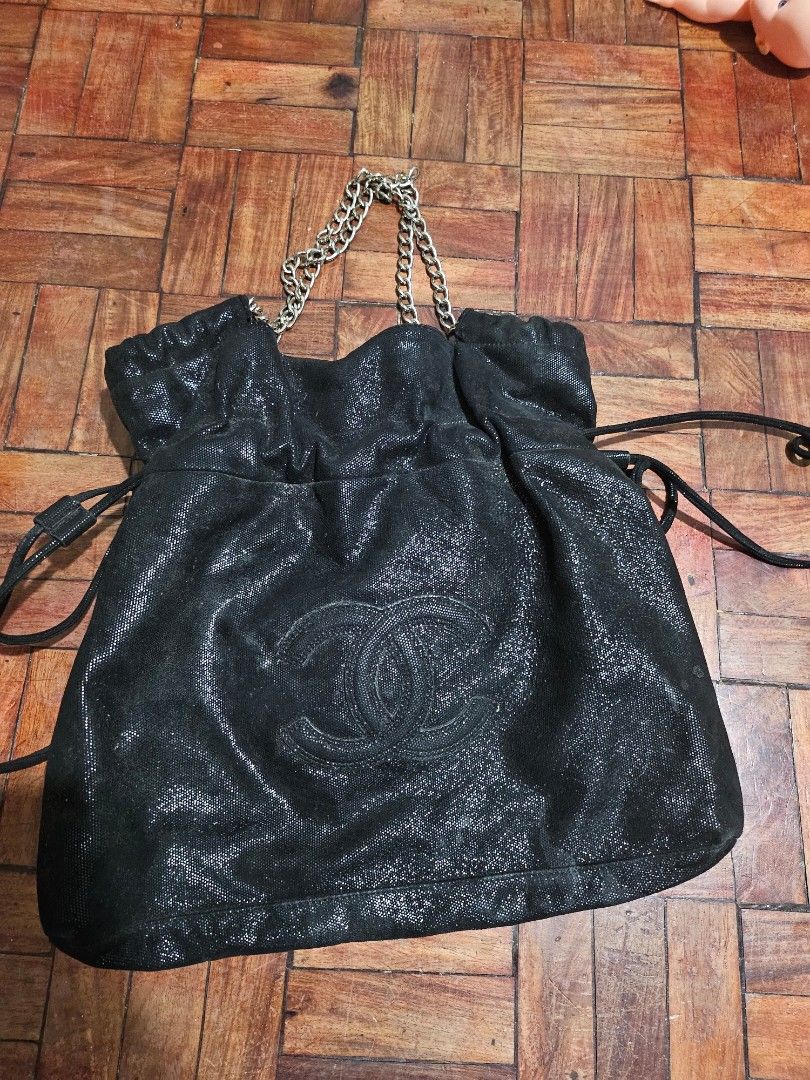 Chanel Drawstring Bag with Chain Strap (Category: Luxury Bags & Wallets) located in Pinamalayan. Submitted by braveheartfiftyfive (Listing ID 1454669207, Image 1). Description: - Chic sparkly black drawstring bag - Features iconic embossed Chanel CC logo - Elegant silver chain strap - Secure drawstring closure - Unique textured material - needs cleaning - Ideal for carrying your daily essentials - medium size.