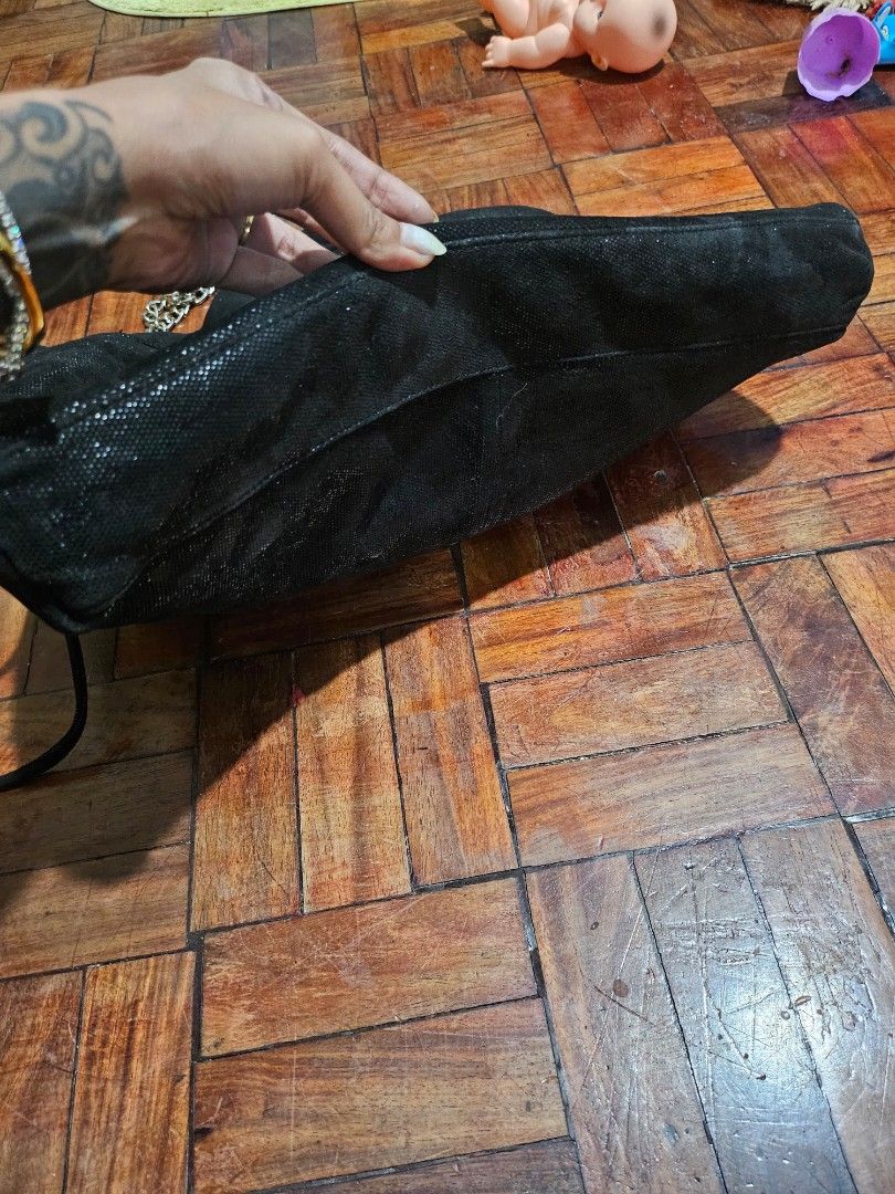 Chanel Drawstring Bag with Chain Strap (Category: Luxury Bags & Wallets) located in Pinamalayan. Submitted by braveheartfiftyfive (Listing ID 1454669207, Image 3). Description: - Chic sparkly black drawstring bag - Features iconic embossed Chanel CC logo - Elegant silver chain strap - Secure drawstring closure - Unique textured material - needs cleaning - Ideal for carrying your daily essentials - medium size.