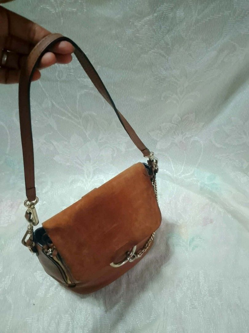 Chloé Faye backpack (Category: Luxury Bags & Wallets) located in Tuguegarao City. Submitted by starzeke (Listing ID 1454746895, Image 3). Description: Chloé Faye backpack features a distinct suede front flap secured by a signature ring and chain closure. [1, 2].
