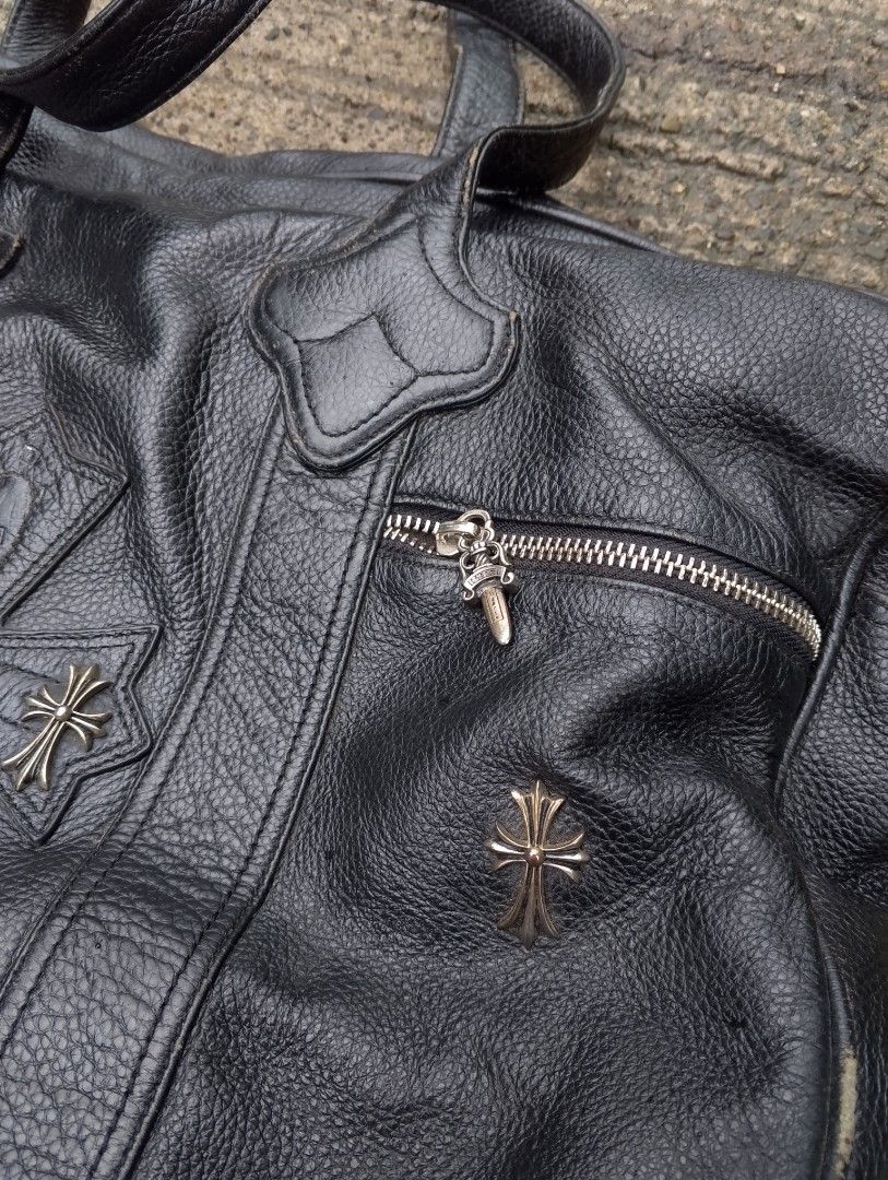 Chrome Hearts Pebbled Leather Bag / Duffel (Category: Luxury Bags & Wallets) located in Baliuag. Submitted by retrovault83 (Listing ID 1454635411, Image 3). Description: Chrome Hearts Pebbled Leather Bag / Duffel ( OFF ONLY ) Front Overlay: Stitched Leather Cemetery Cross patch accented with 3 Silver CH Cross Rivets. Zipper Pulls: Dagger Zip Pulls across compartments (Note: 1 zipper is missing its dagger pull). Exterior Side Studs: Silver Plus/Cr
