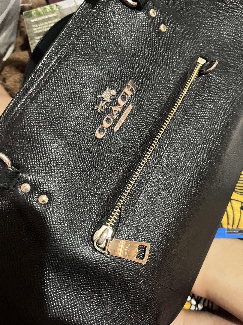 Coach Black Leather Tote Bag (Category: Luxury Bags & Wallets) located in Cabanatuan. Submitted by carou99645 (Listing ID 1454701105, Image 2). Description: - Authentic Coach black leather tote bag - Elegant gold hardware details (faded) - Convenient front zip pocket - Spacious interior with zip and slip pockets - hang tag (nawala na) - Ideal for office and everyday use - konting linis matagal na stock hindi nagagamit..