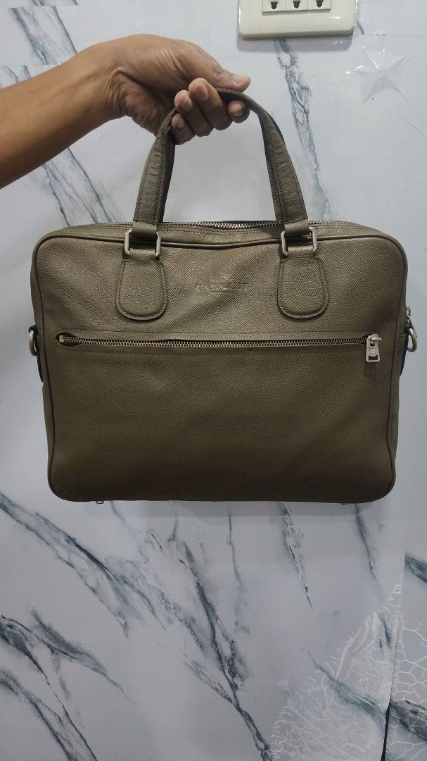 Coach Leather Briefcase Bag (Category: Briefcases) located in Caloocan City. Submitted by aliling30 (Listing ID 1454587944, Image 2). Description: - Coach olive green leather briefcase - Main zip compartment for secure storage - Convenient front zip pocket - Interior zip pocket and patch pocket for organization - Sturdy handles for comfortable carrying - Ideal for professional use or travel.
