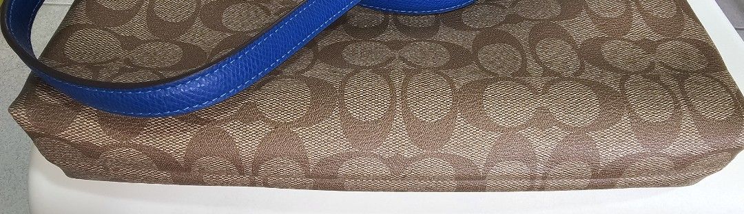 Coach Signature Monogram Crossbody Bag (Category: Luxury Bags & Wallets) located in Paranaque City. Submitted by shop_at_j (Listing ID 1454616982, Image 3). Description: ✨ FOR SALE✨ AUTHENTIC COACH FILE CROSSBODY BAG 🤎 Brown/Tan Signature 💙 Blue Leather Trim ✨ Classic brown & tan Coach monogram signature pattern ✨ Stylish blue leather trim & adjustable strap ✨ Secure zipper closure ✨ Spacious interior for your essentials ✨ Adjustable strap for 