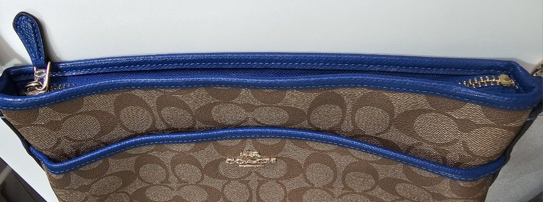 Coach Signature Monogram Crossbody Bag (Category: Luxury Bags & Wallets) located in Paranaque City. Submitted by shop_at_j (Listing ID 1454616982, Image 2). Description: ✨ FOR SALE✨ AUTHENTIC COACH FILE CROSSBODY BAG 🤎 Brown/Tan Signature 💙 Blue Leather Trim ✨ Classic brown & tan Coach monogram signature pattern ✨ Stylish blue leather trim & adjustable strap ✨ Secure zipper closure ✨ Spacious interior for your essentials ✨ Adjustable strap for 