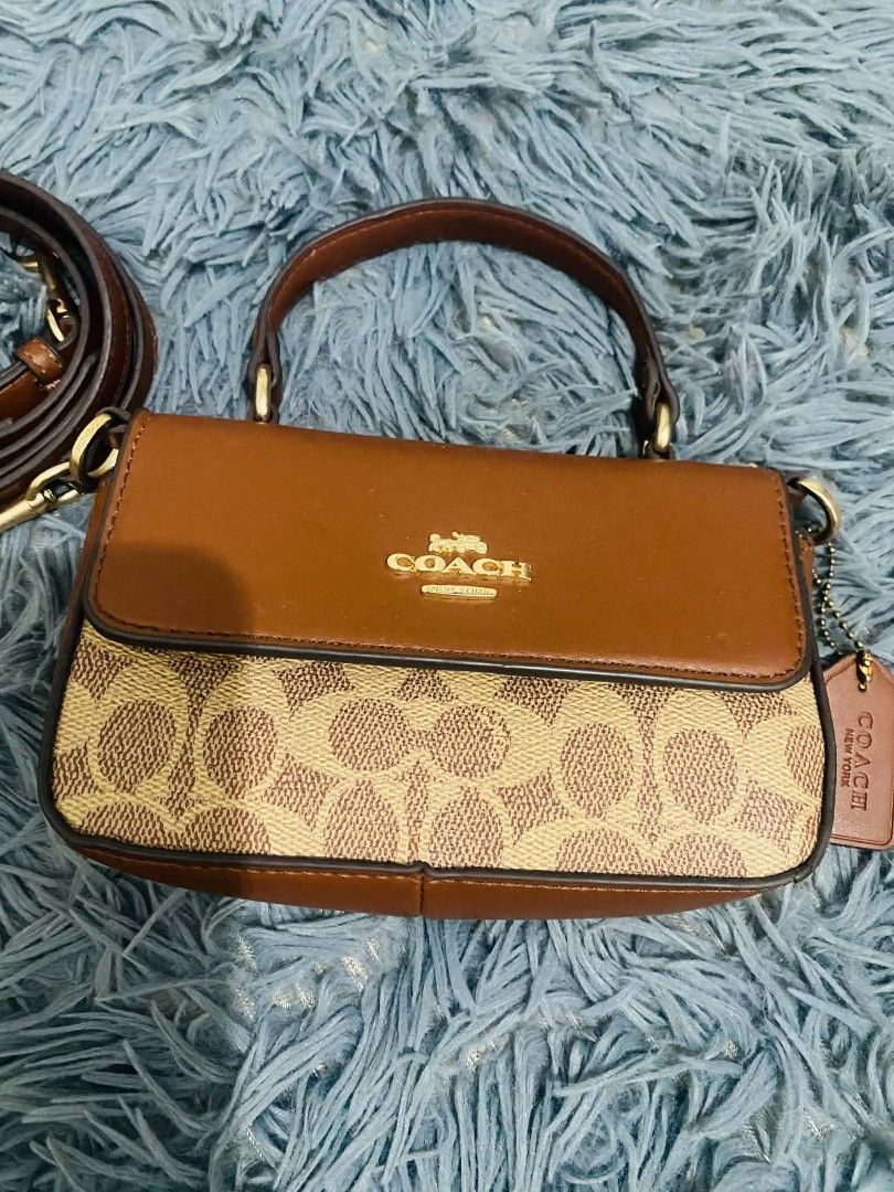 Coach Sling Top Handle Bag (Category: Luxury Bags & Wallets) located in Manila. Submitted by keendog_d33509 (Listing ID 1454683421, Image 2). Description: - Coach sling bag - Signature C print with leather trim and handles - Detachable crossbody strap included - Interior features multiple card slots and a zip pocket - with stain inside the bag -with tag but authenticity not guarantee *You can check all details before you confirm. *NO RETURN, NO R