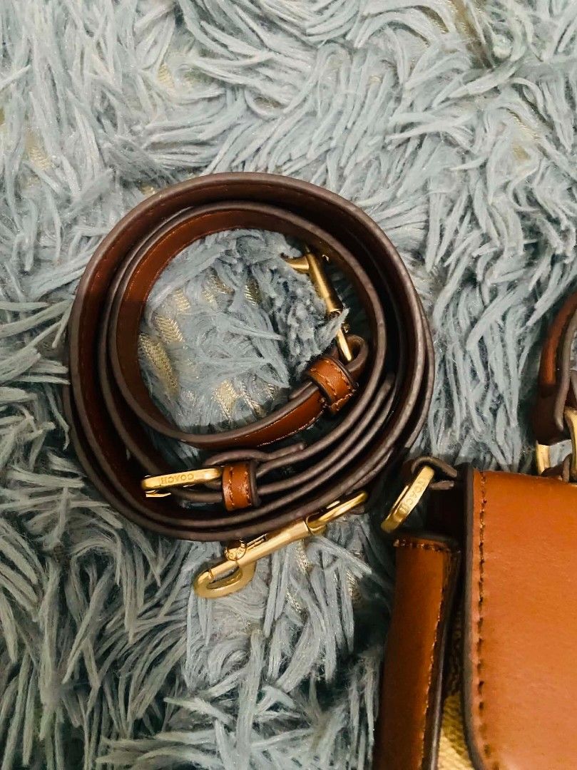 Coach Sling Top Handle Bag (Category: Luxury Bags & Wallets) located in Manila. Submitted by keendog_d33509 (Listing ID 1454683421, Image 3). Description: - Coach sling bag - Signature C print with leather trim and handles - Detachable crossbody strap included - Interior features multiple card slots and a zip pocket - with stain inside the bag -with tag but authenticity not guarantee *You can check all details before you confirm. *NO RETURN, NO R