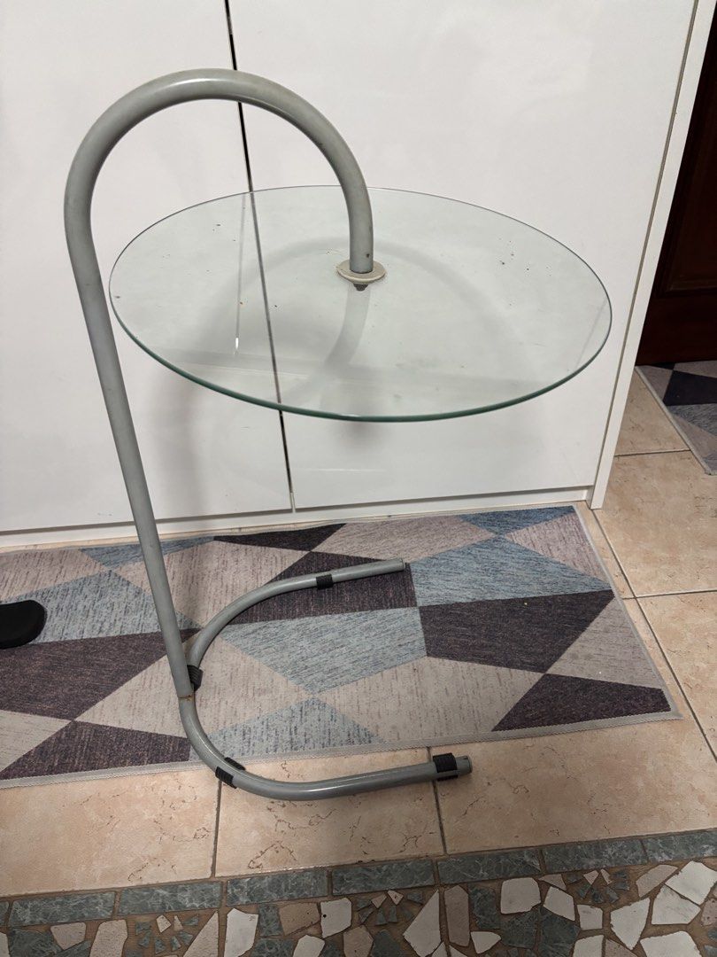 Coffee table (Category: Coffee & Tea Tableware) located in Singapore. Submitted by theworldisbig (Listing ID 1454716356, Image 1). Description: - Modern coffee table - Features a unique curved metal frame - Topped with a clear glass surface - Minimalist and stylish design - Suitable for living rooms or bedside.