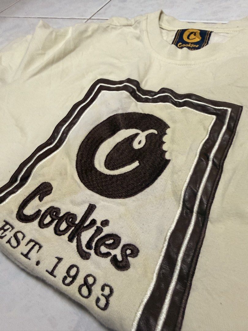 Cookies T-Shirt (Category: Tshirts & Polo Shirts ) located in Manila. Submitted by lostnfound_ph (Listing ID 1454572269, Image 3). Description: - Cream colored Cookies t-shirt - Features iconic Cookies logo with 'Est. 1983' printed below - Tagged size M - Made in China - Great for casual wear.