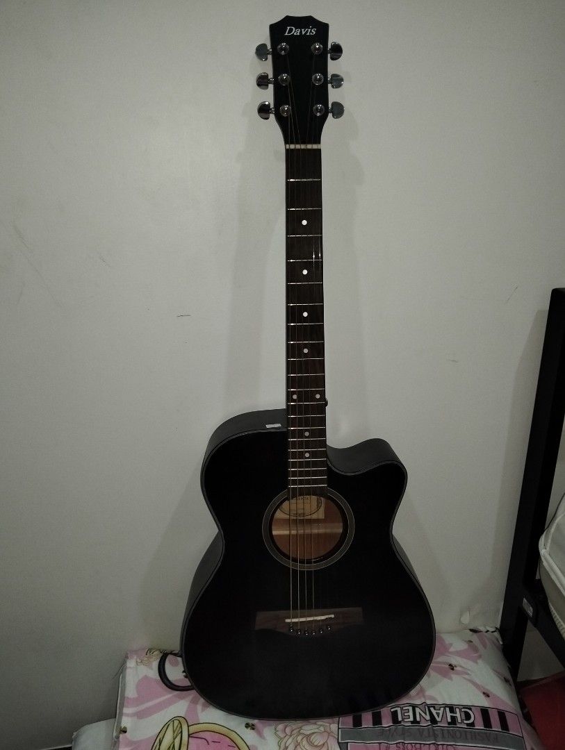 Davis Acoustic Guitar - Dark Brown (Category: Musical Instruments) located in Caloocan City. Submitted by girlshopmcollection (Listing ID 1454663277, Image 3). Description: - Black Davis acoustic guitar - Cutaway body for easier access to higher frets - Dot inlays on the fretboard - Tuners on the headstock for easy tuning - Ready to strum and play - Ideal for beginners or anyone seeking an acoustic guitar.