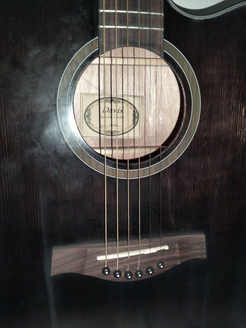 Davis Acoustic Guitar - Dark Brown (Category: Musical Instruments) located in Caloocan City. Submitted by girlshopmcollection (Listing ID 1454663277, Image 2). Description: - Black Davis acoustic guitar - Cutaway body for easier access to higher frets - Dot inlays on the fretboard - Tuners on the headstock for easy tuning - Ready to strum and play - Ideal for beginners or anyone seeking an acoustic guitar.
