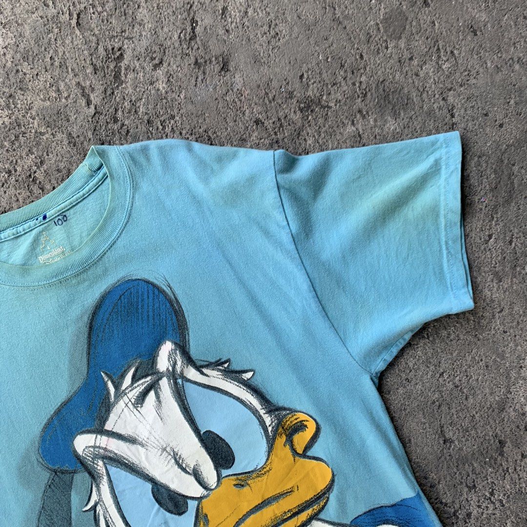Disneyland Donald Duck T-shirt (Category: Tshirts & Polo Shirts ) located in Polangui. Submitted by b0ssl00ts (Listing ID 1454635997, Image 3). Description: - Light blue Disneyland t-shirt - Features a large Donald Duck graphic - Made from 100% preshrunk cotton - Tag indicates it's from Walt Disney World - Size: Large (L) - Perfect for any Disney fan!.