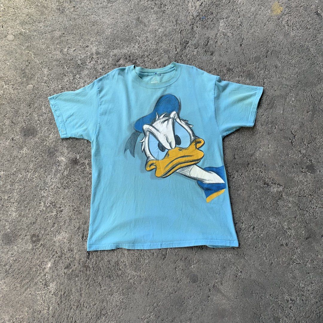 Disneyland Donald Duck T-shirt (Category: Tshirts & Polo Shirts ) located in Polangui. Submitted by b0ssl00ts (Listing ID 1454635997, Image 1). Description: - Light blue Disneyland t-shirt - Features a large Donald Duck graphic - Made from 100% preshrunk cotton - Tag indicates it's from Walt Disney World - Size: Large (L) - Perfect for any Disney fan!.