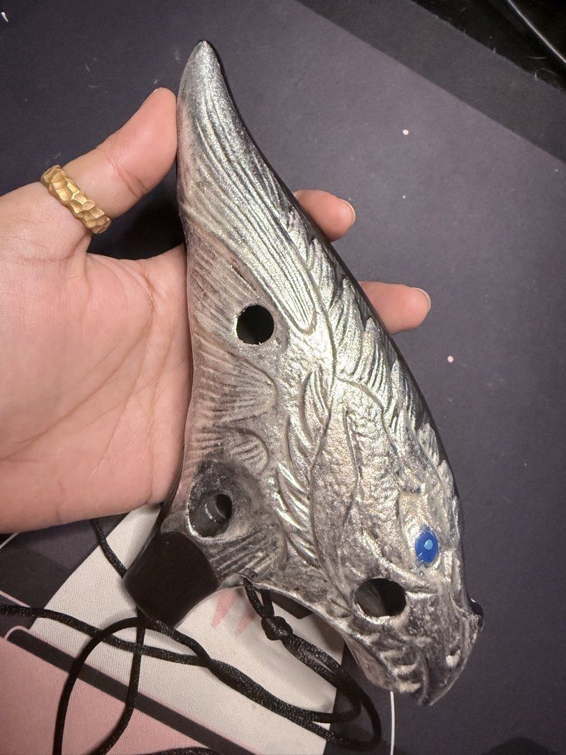 Dragon Ocarina 12-Hole Ceramic Wind Instrument (Category: Musical Instruments) located in Mandaluyong City. Submitted by maricris.sn (Listing ID 1454717756, Image 3). Description: - Unique dragon-shaped ocarina - Metallic silver finish with striking blue gem eyes - Features 12 playable holes - Comes with a convenient black cord - Ideal for collectors and musicians alike - Bought from STL Ocarina website for P4200 RFS: No time to practice. Gatheri