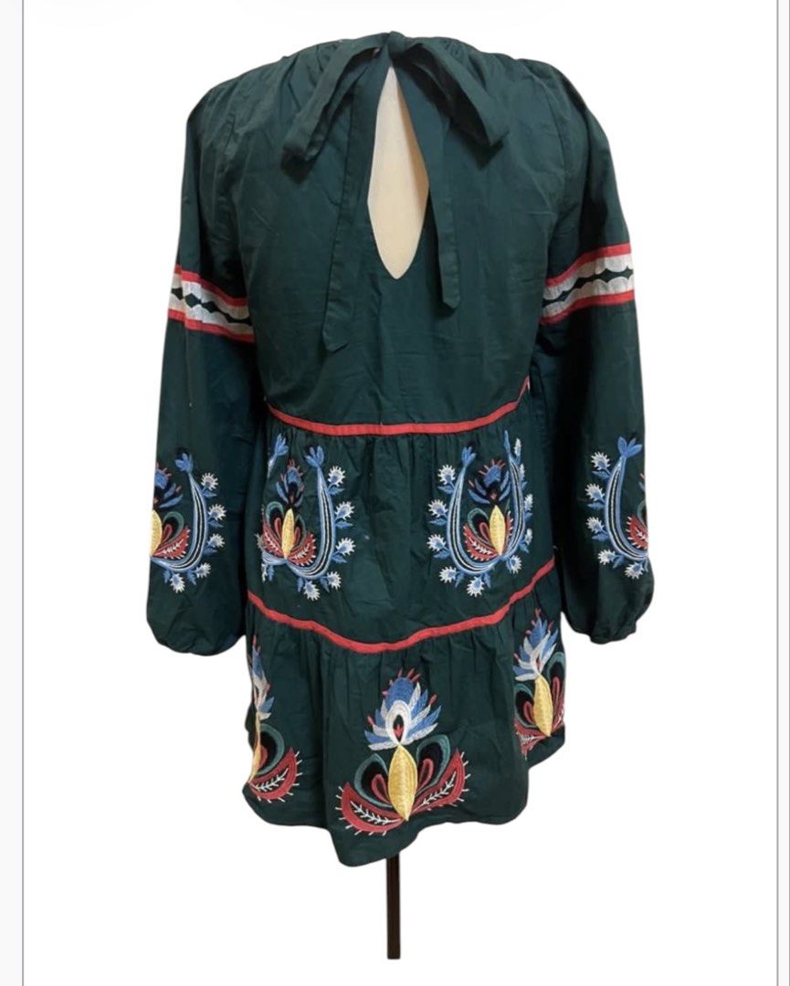 Green Embroidered Tiered Mini Dress (Category: Dresses) located in Quezon City. Submitted by letsdeclutter101 (Listing ID 1454706501, Image 3). Description: - Fun & bohemian green mini dress - width 38' -length 35' - Features colorful embroidery all over - Flattering square neckline - Stylish long puff sleeves - Trendy tiered design with eye-catching red trim - Unique back cutout with adjustable tie closure - Ideal for casual outings, parties, or