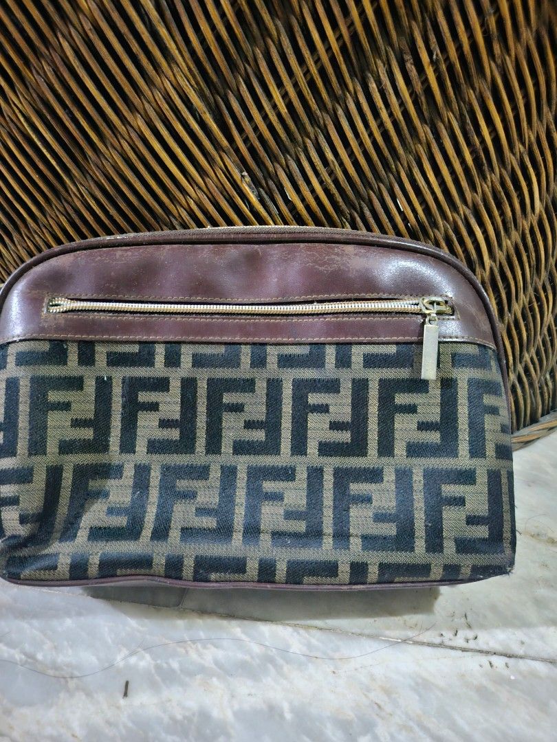Zucca Canvas Pouch Wristlet (Category: Luxury Bags & Wallets) located in Pinamalayan. Submitted by braveheartfiftyfive (Listing ID 1454670823, Image 2). Description: - Classic brown leather trim and wrist strap - Secure zipper closure - Interior card slots for organization - Minor signs of wear on leather trim and corners, adding character - Perfect for carrying your essentials in style.