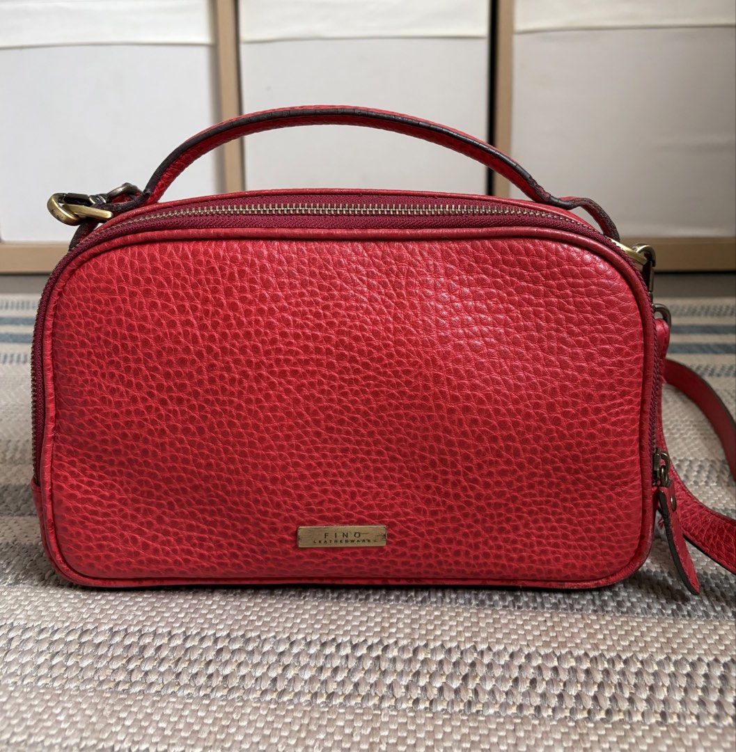 FINO LEATHERWARE Pebbled Leather Crossbody Camera Bag (Category: Cross-body Bags) located in Mandaluyong City. Submitted by kayec93 (Listing ID 1454623070, Image 2). Description: Beautiful Fino Leatherware crossbody camera bag in red pebbled leather with a classic, structured design and metallic Fino brand plate. A great everyday bag for anyone who loves a stylish, timeless leather piece. Condition: lightly used and well-loved * Approx. 27 × 17 ×