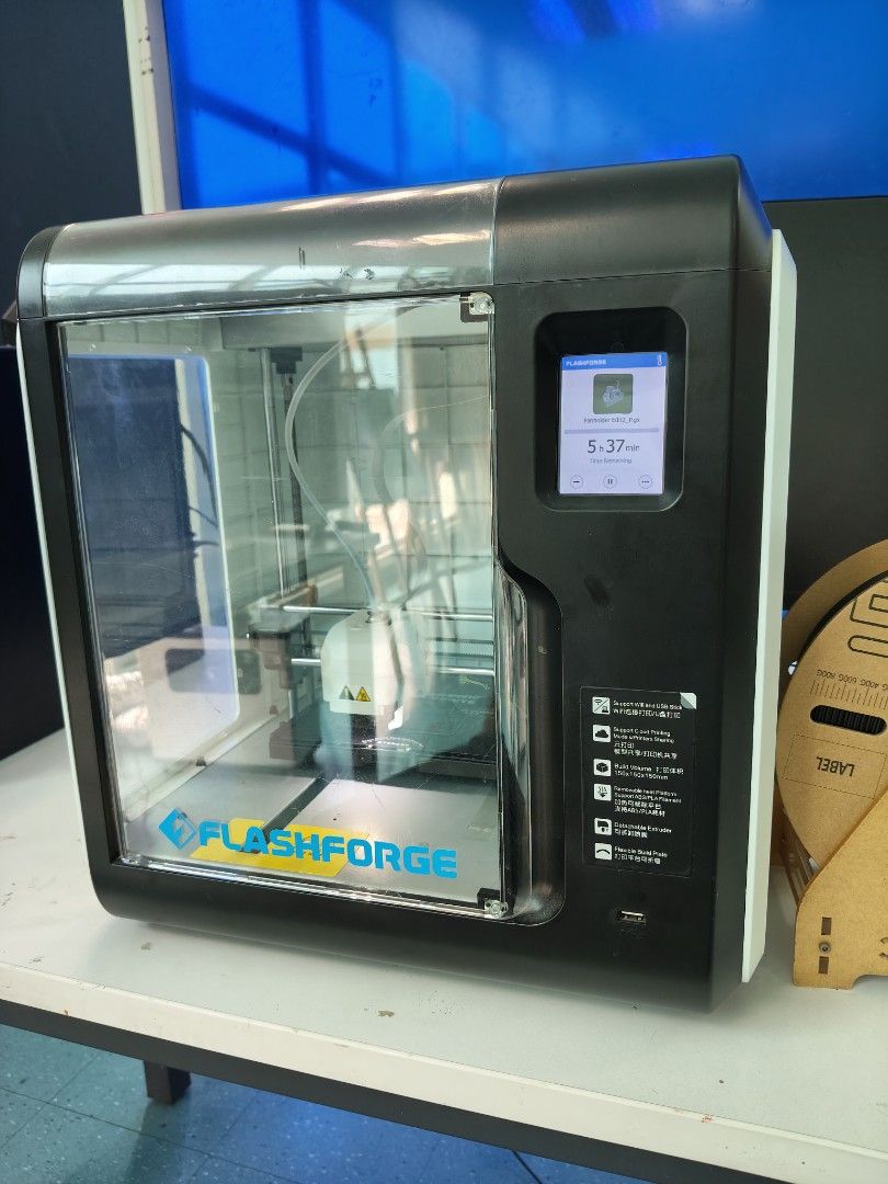 FlashForge 3D Printer (Category: Printers, Scanners & Copiers) located in Kuala Lumpur. Submitted by yauboonhan (Listing ID 1454690474, Image 1). Description: - FlashForge 3D printer - Sleek black and white casing - Features a clear front door - Currently mid-print, showing its operational status - Build plate is included and ready - Perfect for your next creative project free 3pcs print bed sheets.
