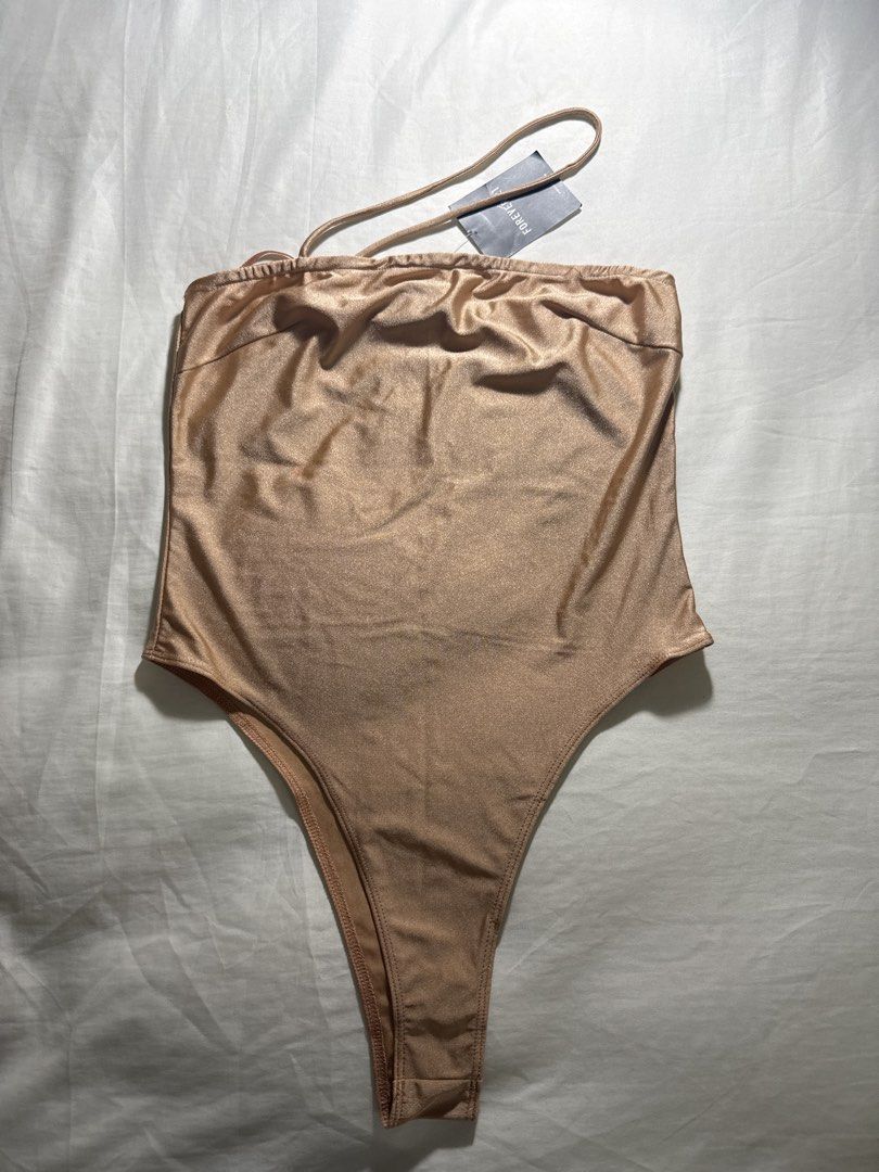 Forever 21 Satin One-Shoulder Bodysuit - Size S (Category: Others Tops) located in Quezon City. Submitted by minispirea (Listing ID 1454717778, Image 1). Description: - Brand new with original tag attached - See 2nd image for minor loose seam in front • On hand & ready to ship • More photos/videos available upon request • Pay as you order • No returns or exchanges Location: Quezon City / BGC Delivery: • Weekdays — same-day evening or next-day del